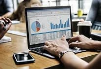 Analyst reviewing dashboards on a laptop