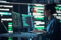 Developer working at a wall of monitors