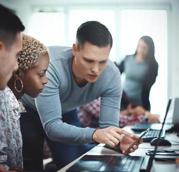 Developers reviewing code together at a desk