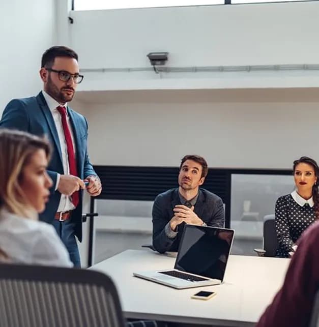 Team discussing work around a table in an office