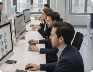 Analysts working at a row of monitors displaying research dashboards