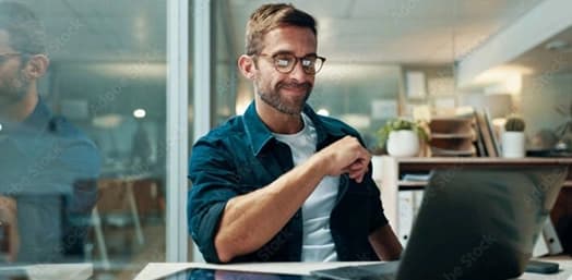 Analyst smiling while reviewing research on a laptop