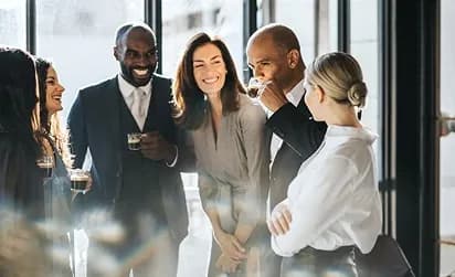 A group of colleagues sharing coffee and conversation