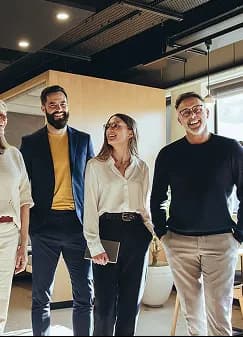 Colleagues laughing together in a modern office