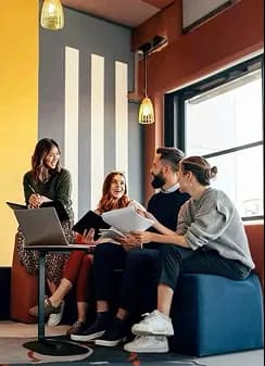 Colleagues chatting in a colorful office lounge