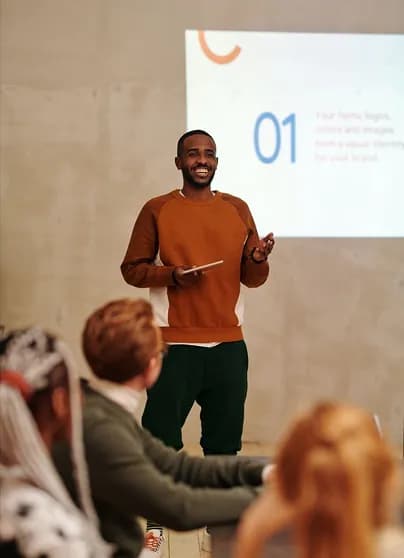 Speaker presenting to colleagues in a bright room