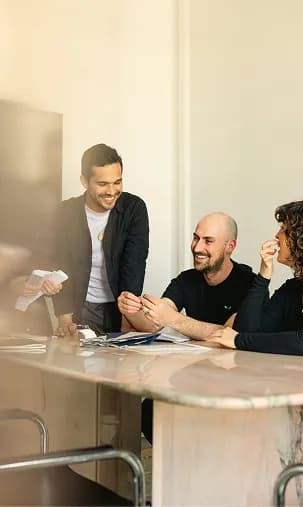 Colleagues gathered around a table in a meeting