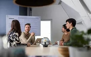 Colleagues on a video call in a meeting room
