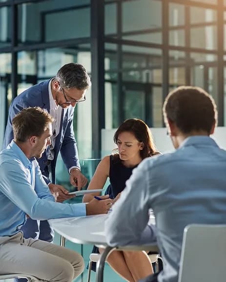 Team collaborating around a table in a bright workspace