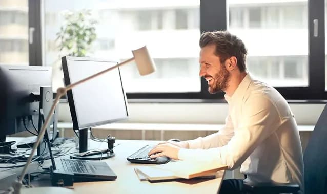 Developer working at a desk beside a window