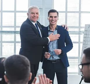 Colleagues congratulating each other at a meeting