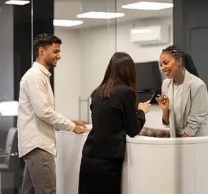 Colleagues talking at a reception desk