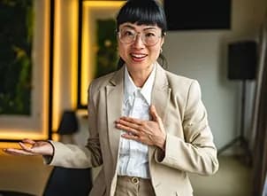 Presenter speaking with open hands in a meeting room