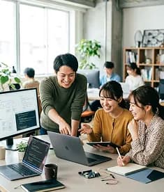 Colleagues looking at a screen together at a shared desk
