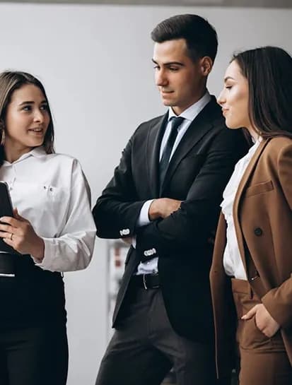 Three colleagues talking together in an office