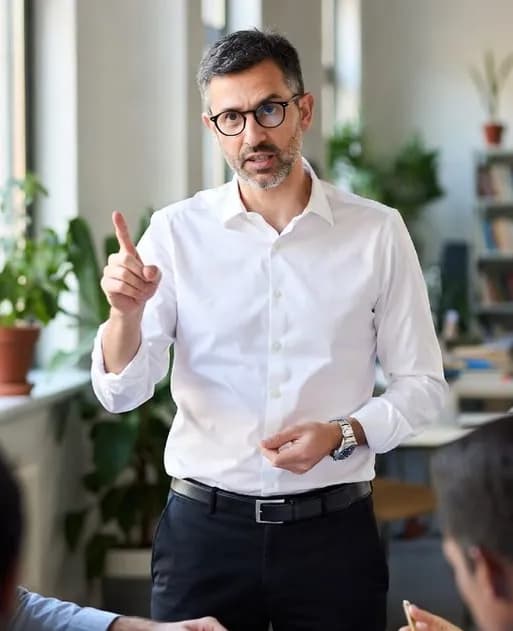 A professional making a point while speaking to colleagues