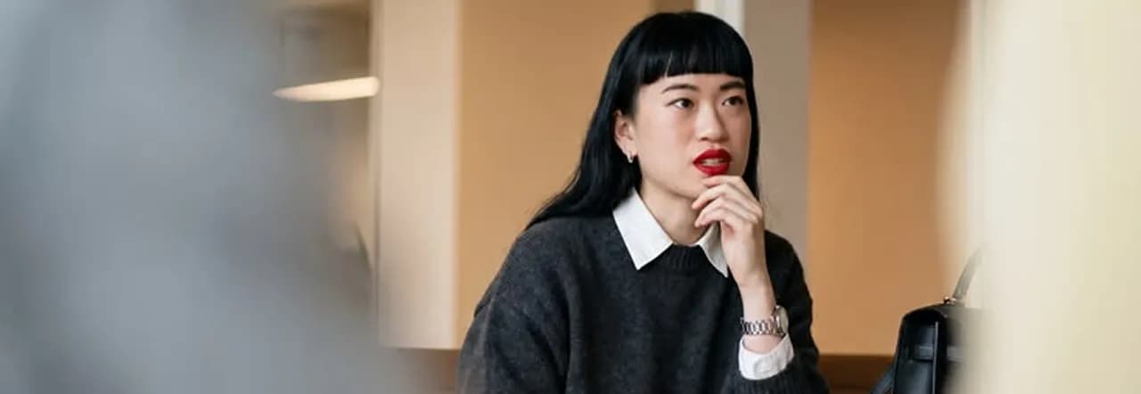 A professional listening thoughtfully in a meeting